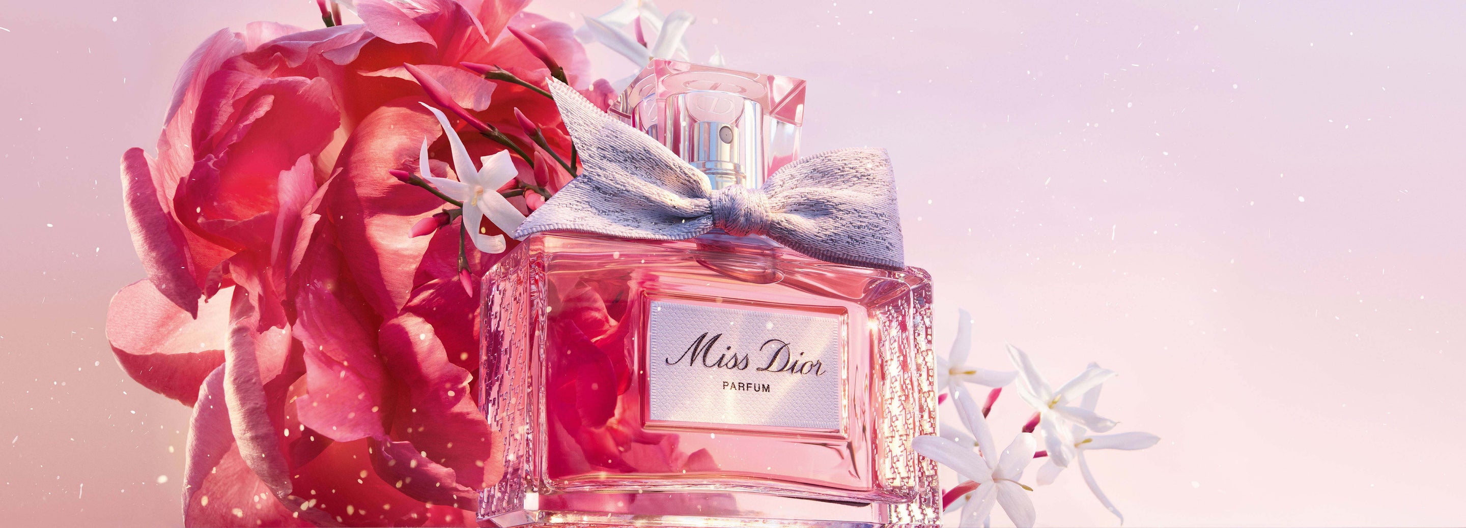 粉紅色花卉背景下的Miss Dior香精